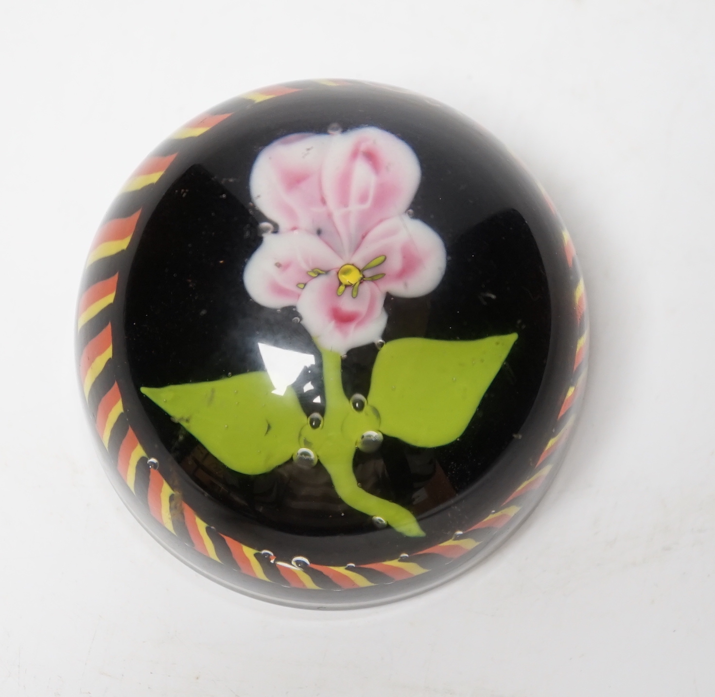 A glass ‘Flower’ paperweight, black ground, possibly Belgian, 8.5cm diameter